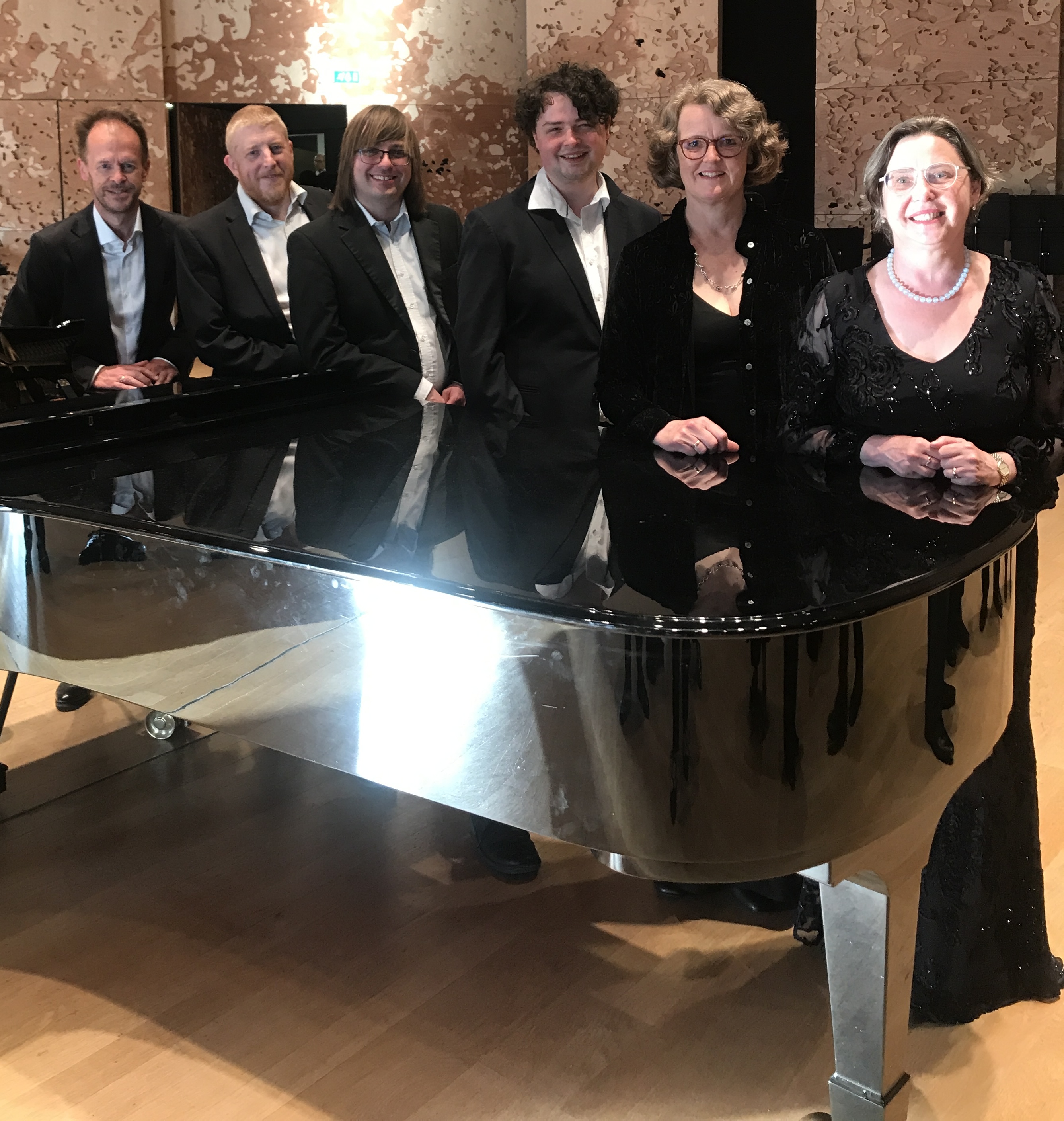 St Botolph's Singers around a piano at the Philharmonie de Paris